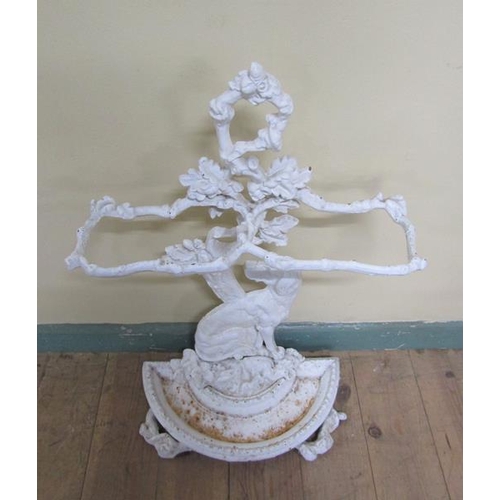 33 - A Victorian cast iron stick stand cast as a seated dog under a tree, white painted.  72cms h.