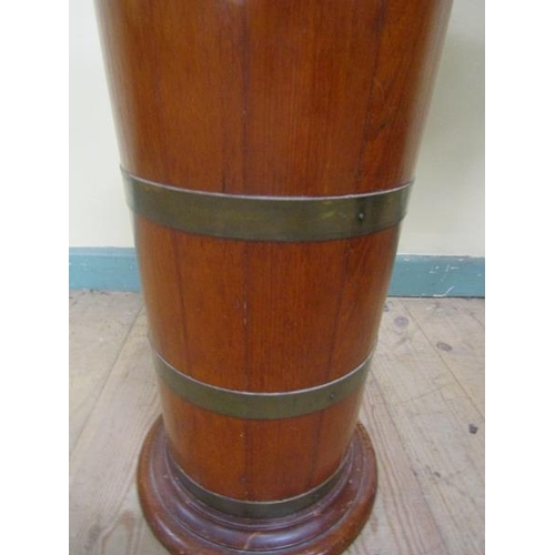 537 - A late 19c mahogany stick stand of cylindrical form, brass banded and supported on a circular moulde... 