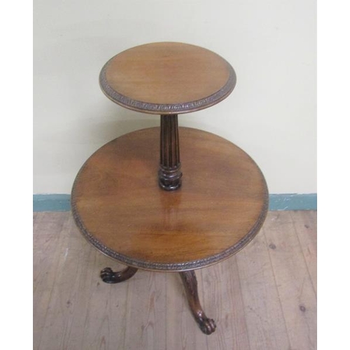 543 - A 19c mahogany two tier dumb waiter, revolving and having a fluted and baluster turned column on thr... 