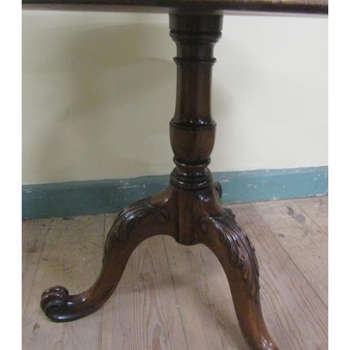 543 - A 19c mahogany two tier dumb waiter, revolving and having a fluted and baluster turned column on thr... 