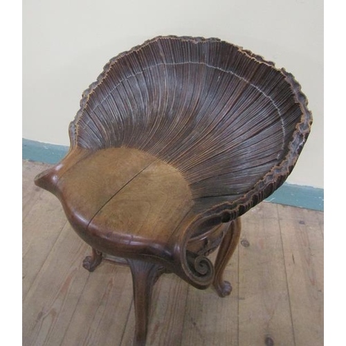 567 - A 19c Italian carved walnut adjustable grotto stool in the form of an open shell, raised on a centra... 