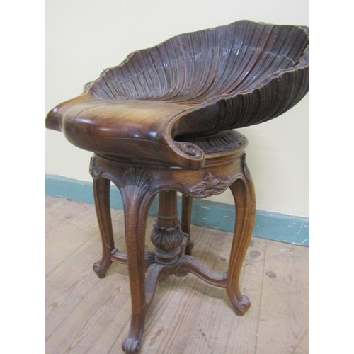 567 - A 19c Italian carved walnut adjustable grotto stool in the form of an open shell, raised on a centra... 