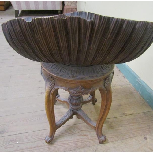 567 - A 19c Italian carved walnut adjustable grotto stool in the form of an open shell, raised on a centra... 