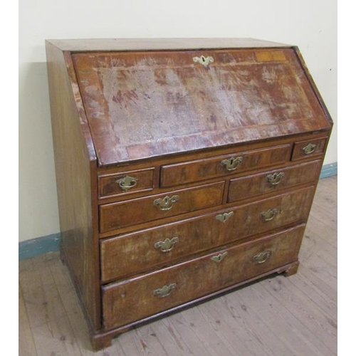 569 - A mid Georgian figured walnut veneered cross banded bureau with fall front and fitted interior over ... 