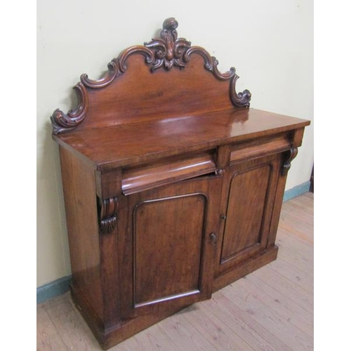 579 - A mid Victorian panel back chiffonier, the panel back with applied scroll mouldings and fitted two f... 