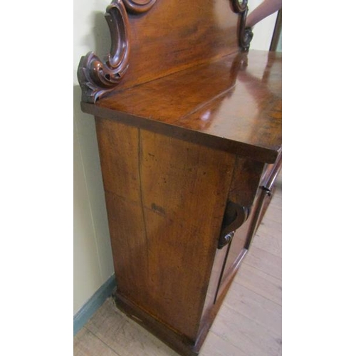 579 - A mid Victorian panel back chiffonier, the panel back with applied scroll mouldings and fitted two f... 