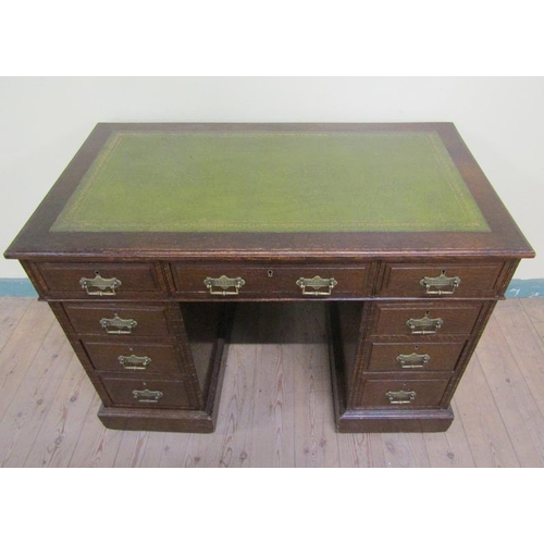 581 - A late Victorian oak pedestal desk of rectangular form, the top with moulded edge and having a green... 