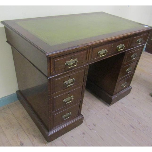 581 - A late Victorian oak pedestal desk of rectangular form, the top with moulded edge and having a green... 