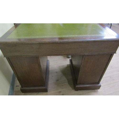 581 - A late Victorian oak pedestal desk of rectangular form, the top with moulded edge and having a green... 