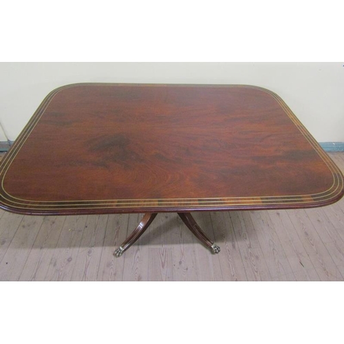 582 - A Regency figured mahogany rosewood and brass rail cross banded breakfast table, tilt top on a pedes... 