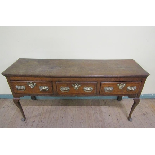 601 - A late 18c Midlands oak three drawer dresser base, the drawers with pierced brass back plates and es... 