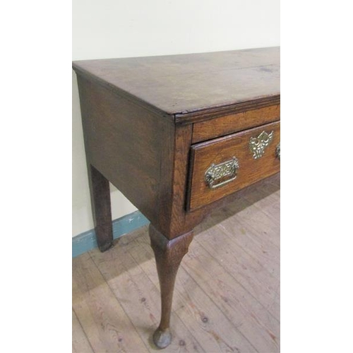 601 - A late 18c Midlands oak three drawer dresser base, the drawers with pierced brass back plates and es... 