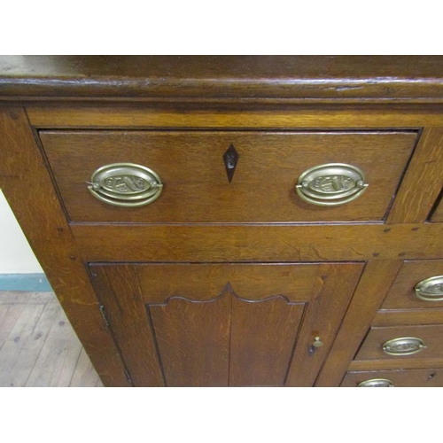 602 - An early 18c English oak three drawer dresser with a panel back rack having three open shelves under... 