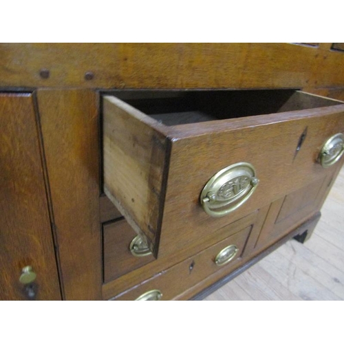 602 - An early 18c English oak three drawer dresser with a panel back rack having three open shelves under... 