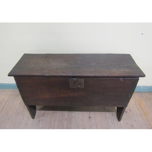 604 - A mid 17c oak five plank coffer with simple chip carving to top edge and sides having later brass st... 