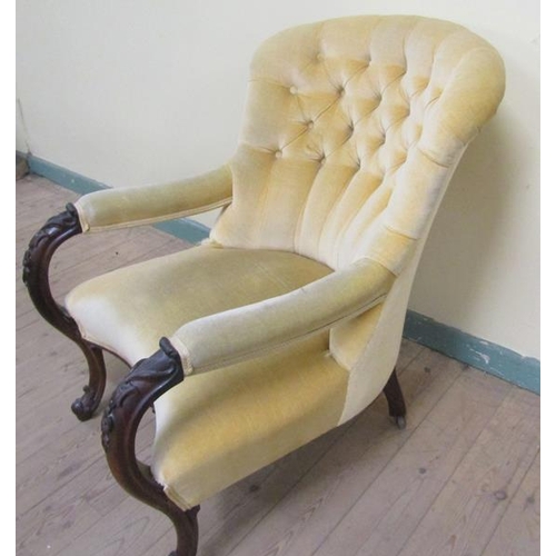 613 - A mid Victorian walnut carved show frame and upholstered armchair with scroll carved feet to the fro... 