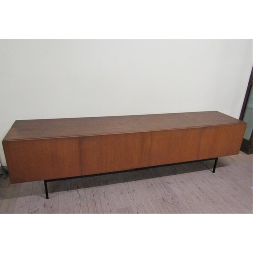 619 - An Ideal Heim teak sideboard of substantial form fitted with six pull-out shelves and one deep drawe... 