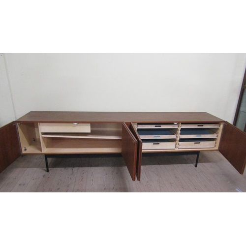 619 - An Ideal Heim teak sideboard of substantial form fitted with six pull-out shelves and one deep drawe... 