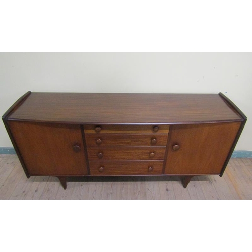 624 - A 1970s Younger Limited teak sideboard fitted four graduated central drawers flanked by two shelved ... 