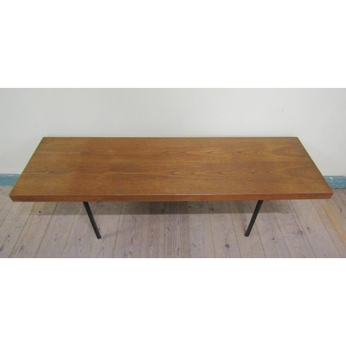 630 - A 1970's teak low table by Ideal Heim of rectangular form supported on black painted straight steel ... 