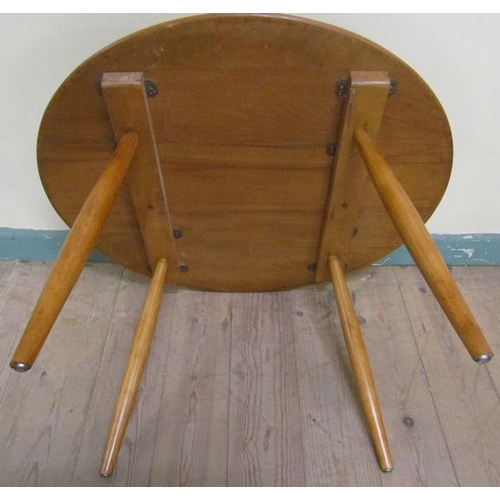 631 - An Ercol teak circular low table on four splayed baluster legs.  75cms d x 46cms h.