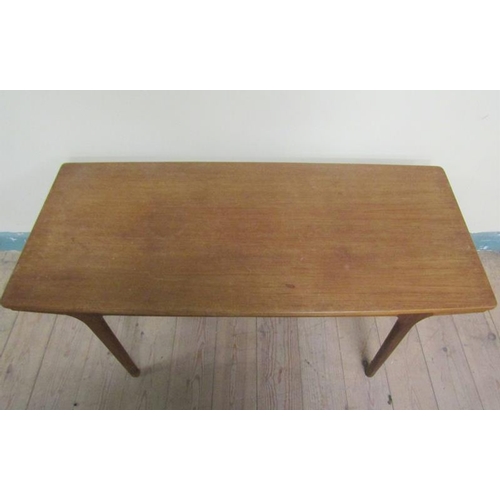 632 - A 1970's teak low table of rectangular shaped form with two pull out end shelves and supported on ci... 