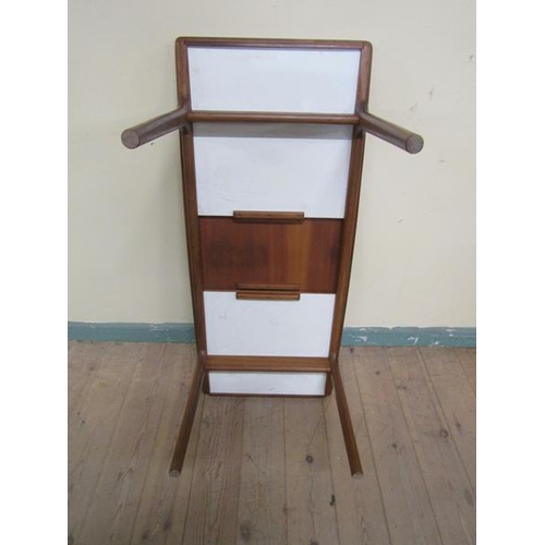 632 - A 1970's teak low table of rectangular shaped form with two pull out end shelves and supported on ci... 