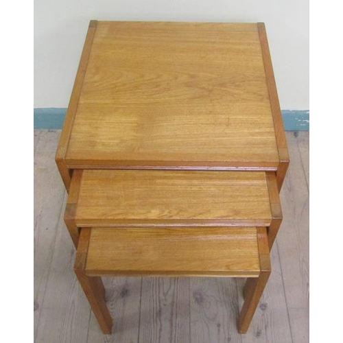 635 - A nest of three 1970's teak occasional tables, the largest 53cms w x 53cms h.