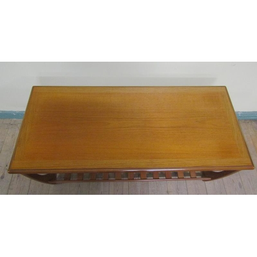 637 - A G Plan teak low table of rectangular form with moulded edge having a slatted under tier shelf.  11... 