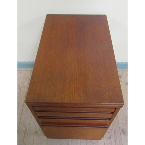 638 - A 1970's teak office cabinet by Ideal Heim with hinged fold over revolving table top and having thre... 