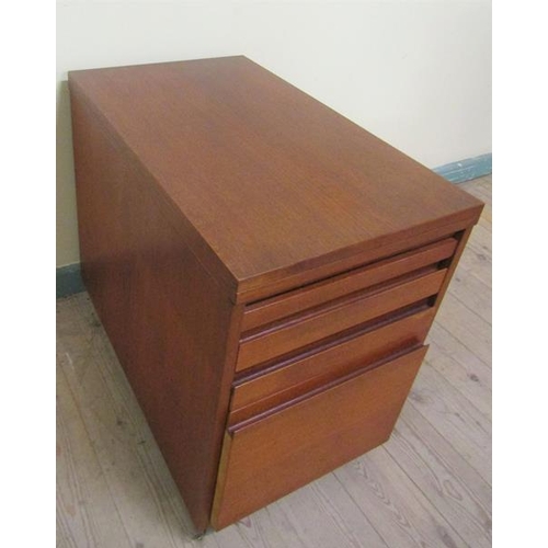 638 - A 1970's teak office cabinet by Ideal Heim with hinged fold over revolving table top and having thre... 