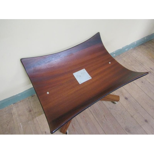 639 - A figured mahogany pedestal stool with a dished rectangular seat, chromium column on an x frame base... 