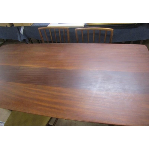 640 - A 1970's teak dining table together with a set of six spindle back dining chairs with faux leather u... 