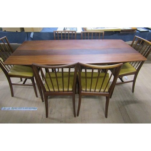 640 - A 1970's teak dining table together with a set of six spindle back dining chairs with faux leather u... 