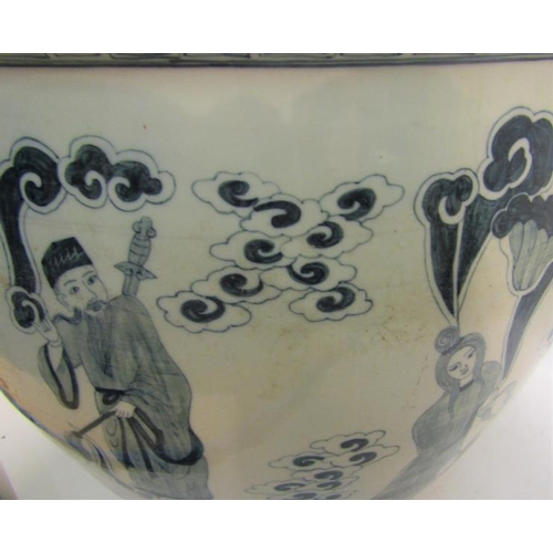 365 - An Oriental fish bowl decorated blue on white with figures amongst the clouds and with upper key pat... 