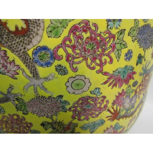 366 - An Oriental fish bowl decorated with dragons amongst flowers on a yellow background.  37cms dia x 32... 