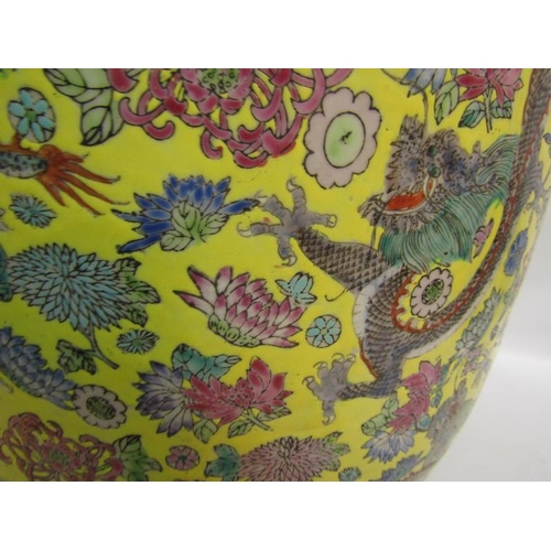 366 - An Oriental fish bowl decorated with dragons amongst flowers on a yellow background.  37cms dia x 32... 