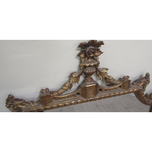 598 - A mid Georgian style gilt wooden stucco wall mirror within a serpentine gilded frame having an open ... 