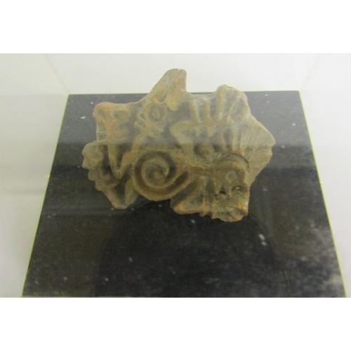 70 - A fragment of a pre-Colombian pottery figure with arms and legs missing and ear lobe, 19cms l.  Toge... 