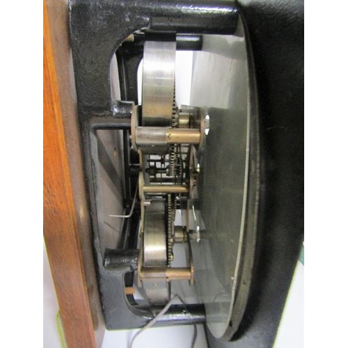 14 - An early 20c movement from an industrial time clock complete with its mounting bracket now mounted o... 