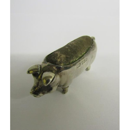 223 - An Edwardian silver pig pin cushion, makers mark for Levi & Salaman, Birmingham 1903.  5cms l.