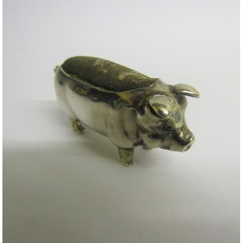 223 - An Edwardian silver pig pin cushion, makers mark for Levi & Salaman, Birmingham 1903.  5cms l.