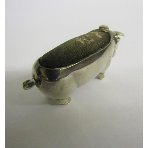 223 - An Edwardian silver pig pin cushion, makers mark for Levi & Salaman, Birmingham 1903.  5cms l.