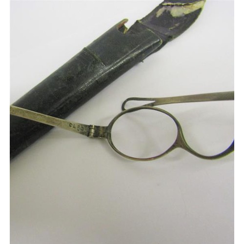 225 - A pair of late Georgian silver spectacles in leather case.  Birmingham 1807.  11cms w.