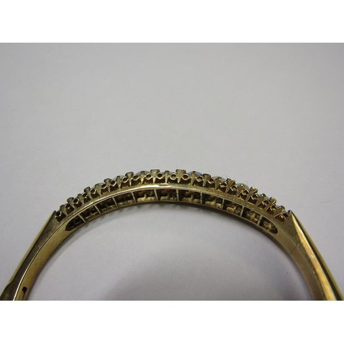 202 - A 9ct gold bangle set with eleven graduated opals - 23g overall.