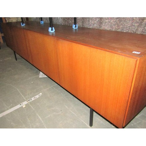 619 - An Ideal Heim teak sideboard of substantial form fitted with six pull-out shelves and one deep drawe... 