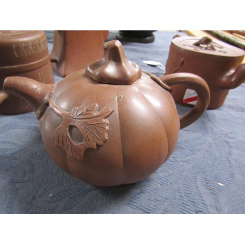 356 - A collection of four 19c Oriental red clay teapots with applied moulded decoration, two with panels ... 