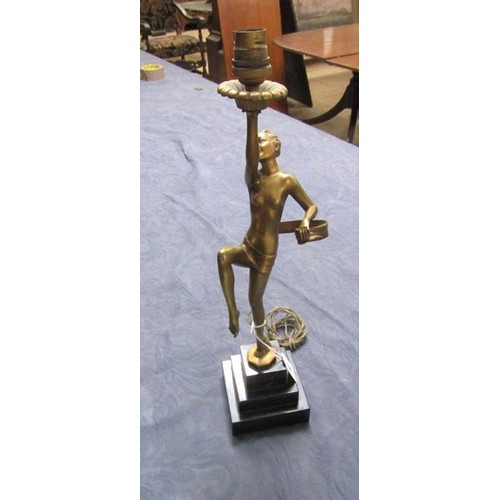 64 - An art deco gilt metal dancing figure table lamp supported on stepped marble base, electrolier.  The... 