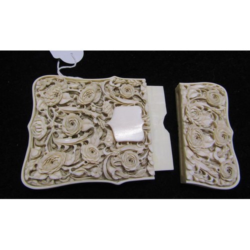 115 - A late 19c ivory card case carved in high relief with panels of leaf and flowers, and through the re... 