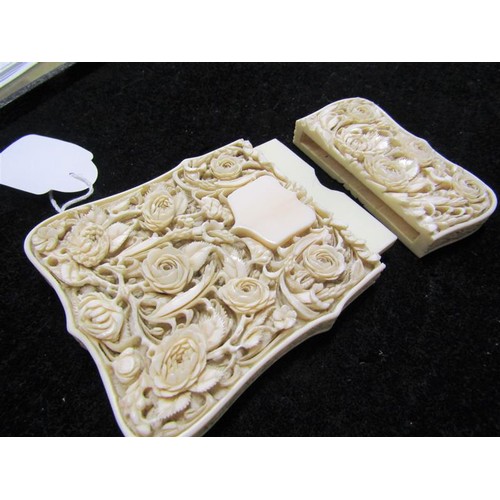 115 - A late 19c ivory card case carved in high relief with panels of leaf and flowers, and through the re... 